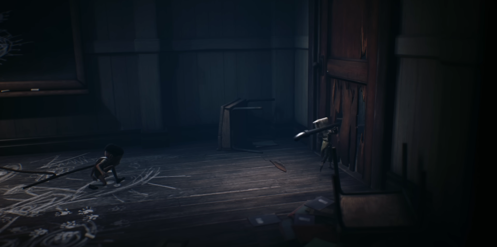Little Nightmares child crouching in dark wooden room