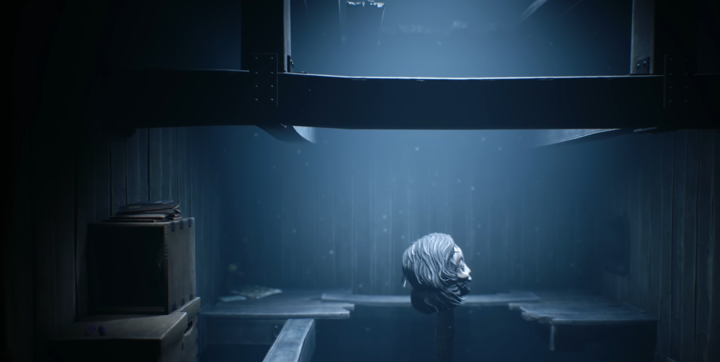 Severed head floating in dark blue room