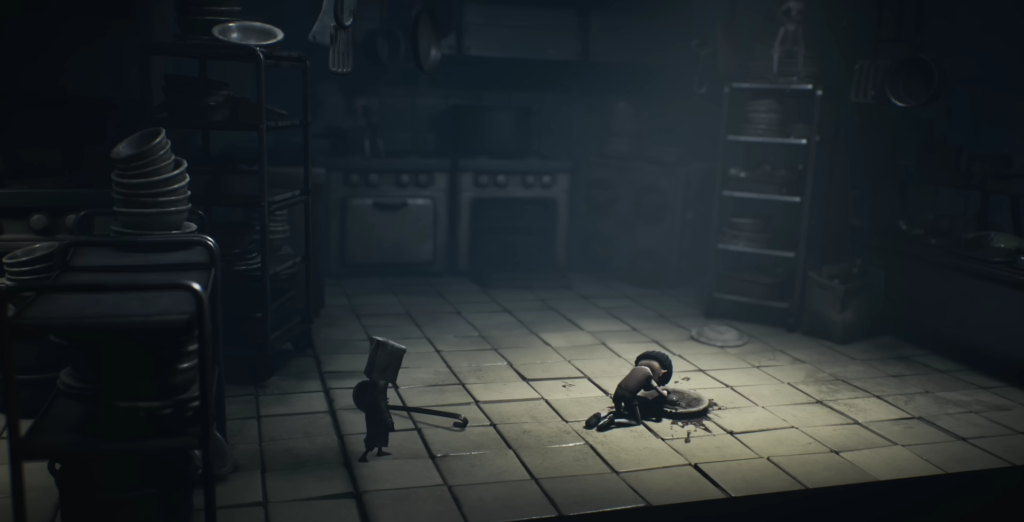Little Nightmares characters stand in dark kitchen room