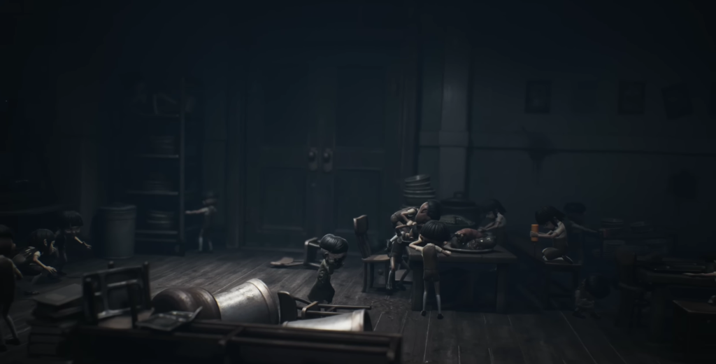 Children huddle around table in dark room