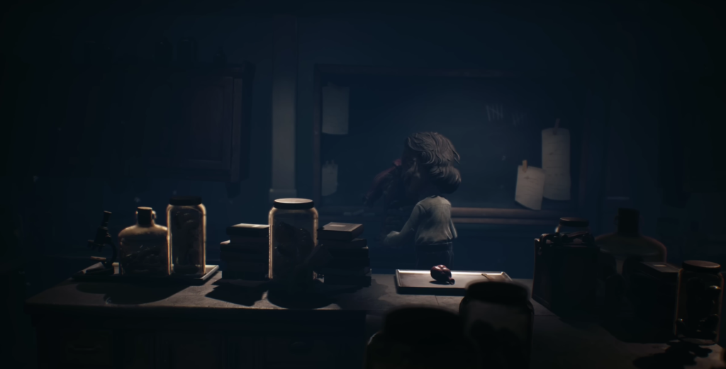 Girl hugging another child in dark classroom