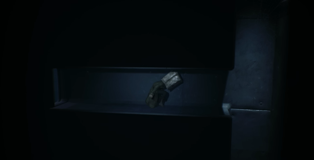 Gloved hand holding flashlight inside dark metal vent