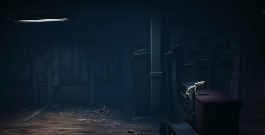 Small figure climbing cabinet in dark room