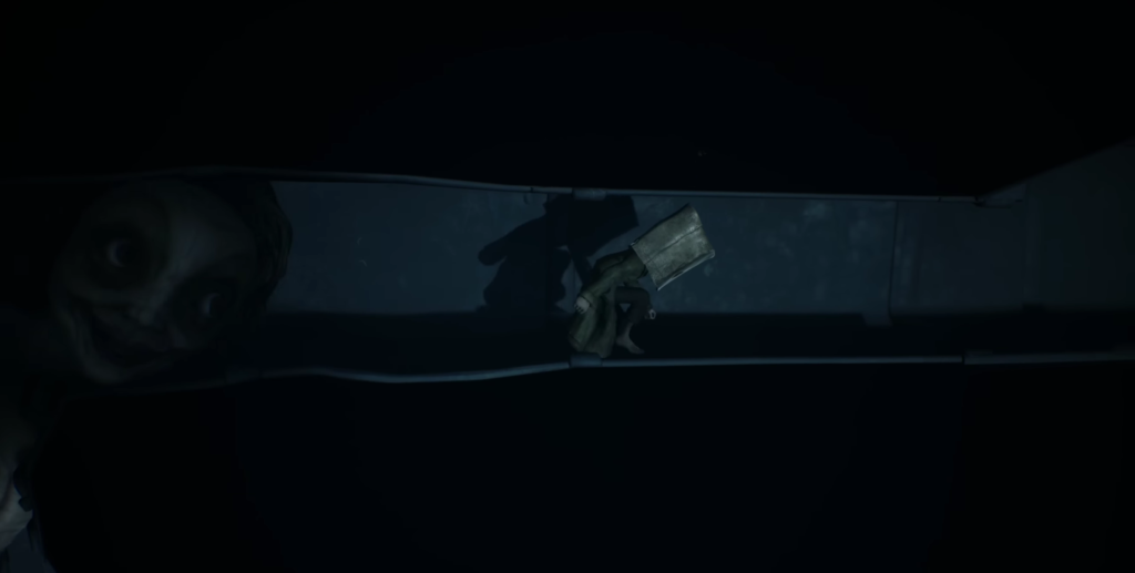 Hand holding handgun in dark blue corridor