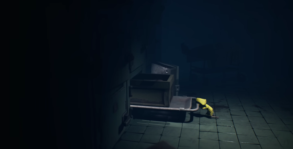 Six from Little Nightmares crawling under metal cart