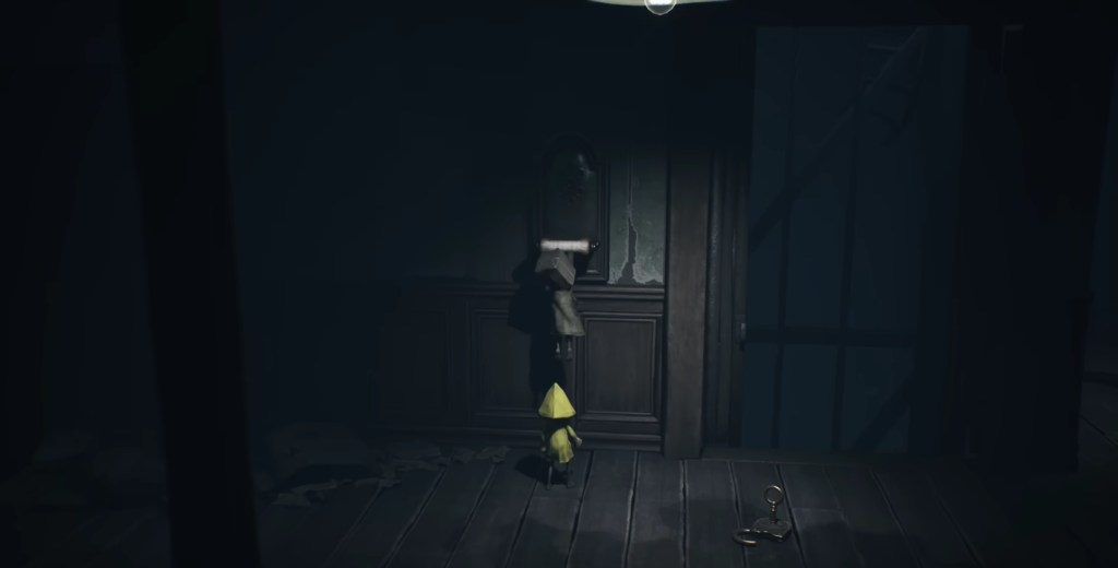 Six from Little Nightmares reaching for wall handle indoors