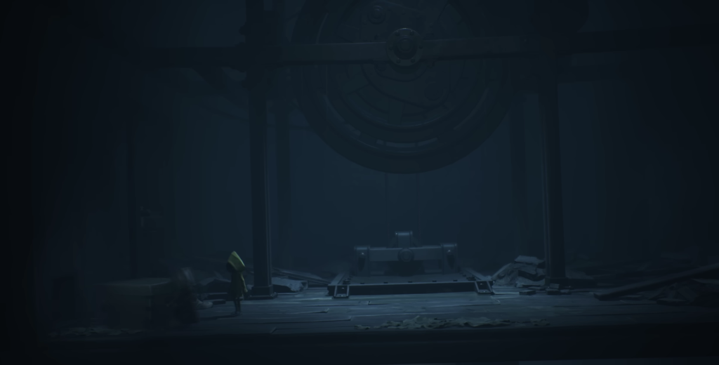 Yellow raincoat figure stands in dark industrial room