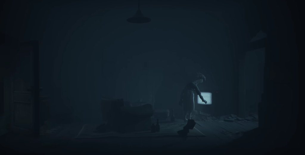 Person reaching toward glowing TV in dark room