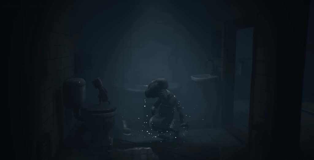 Small figure crouching in dark bathroom near toilet