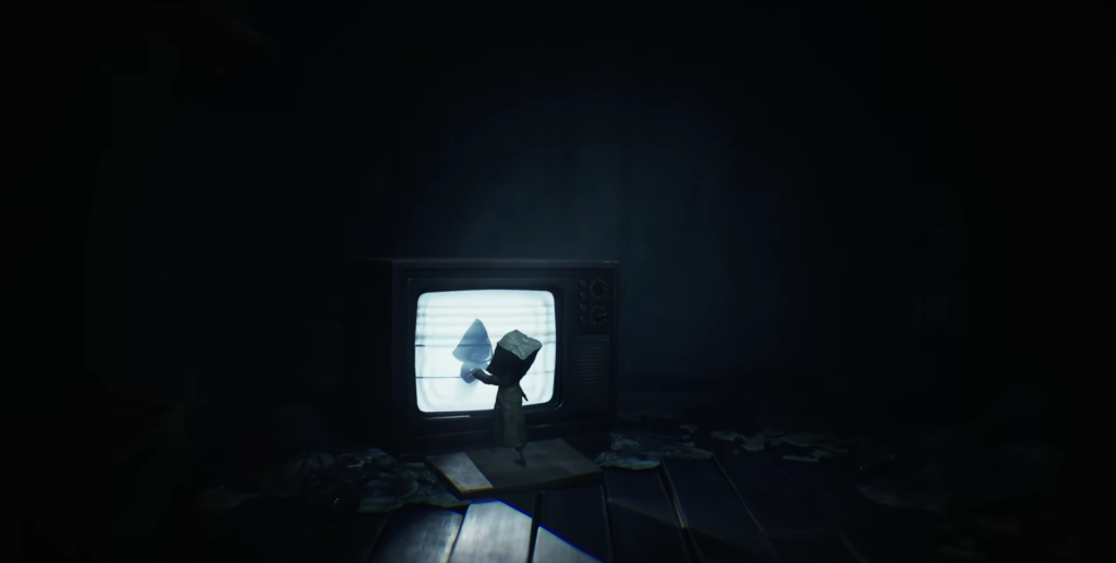 Little Nightmares Six watches television in dark room