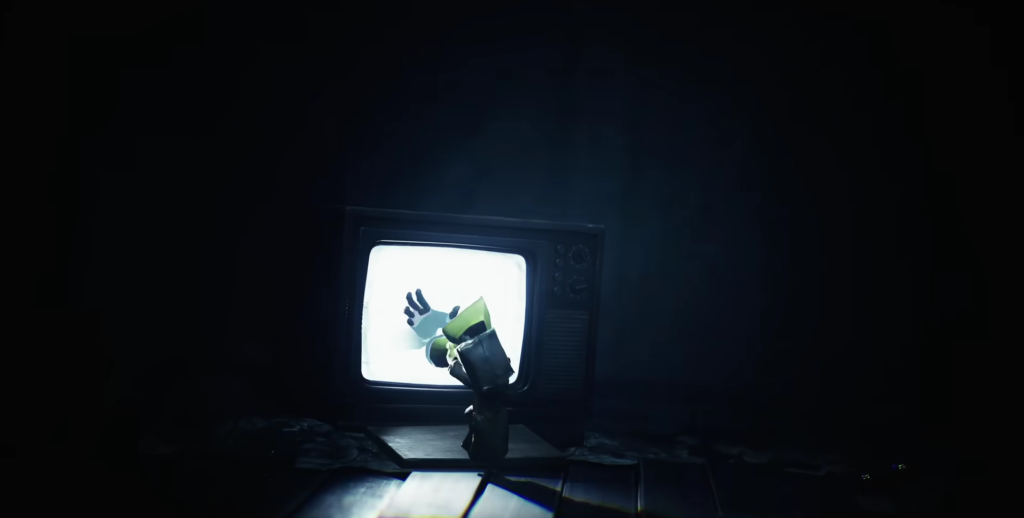 Six from Little Nightmares reaches toward television screen