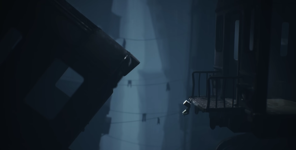 Small figure jumps between platforms in dark blue industrial area