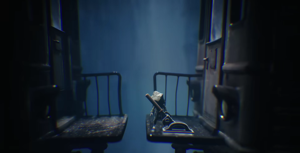 Little Nightmares Mono stands on train seat in carriage