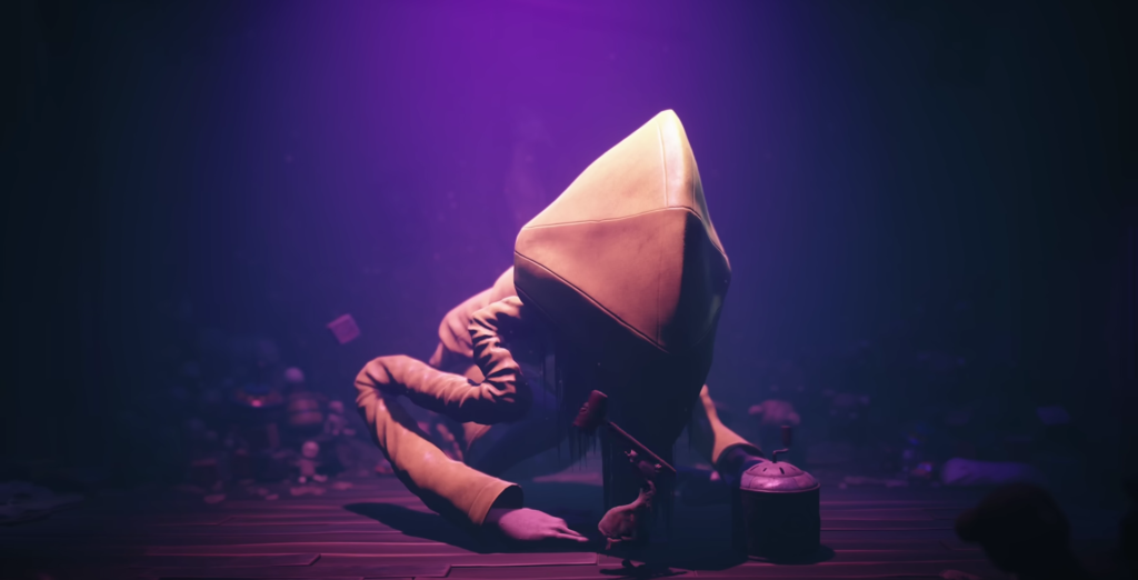 Six from Little Nightmares crouching on dark floor