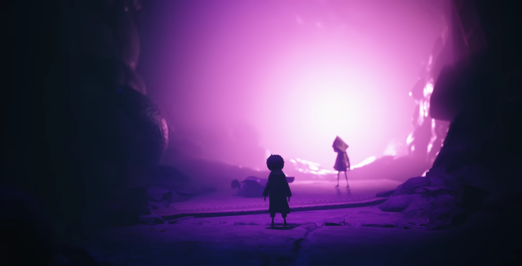 Two silhouetted figures stand in purple-lit cave