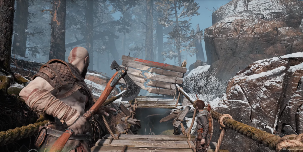 Kratos aims axe at wooden barrier in snowy forest