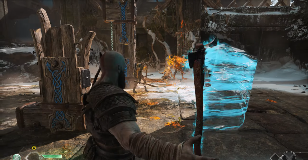 Kratos fights enemies with blue shield in arena