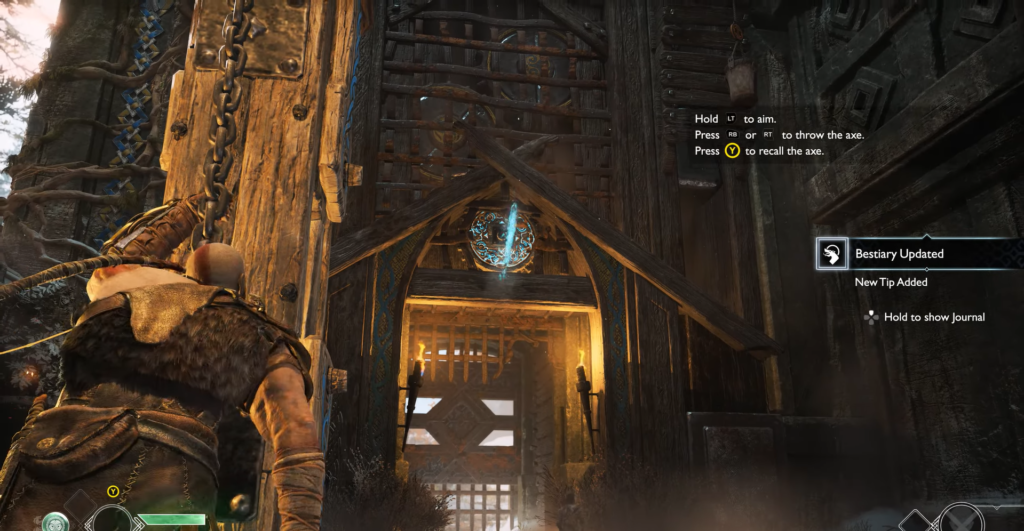 Kratos aims axe at wooden gate in God of War
