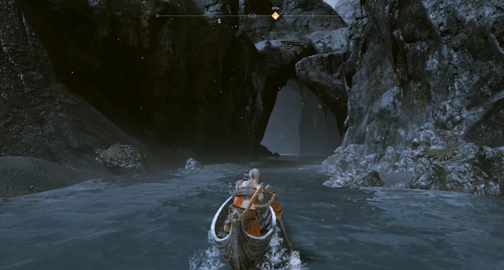 Kratos rowing boat through rocky cave in God of War