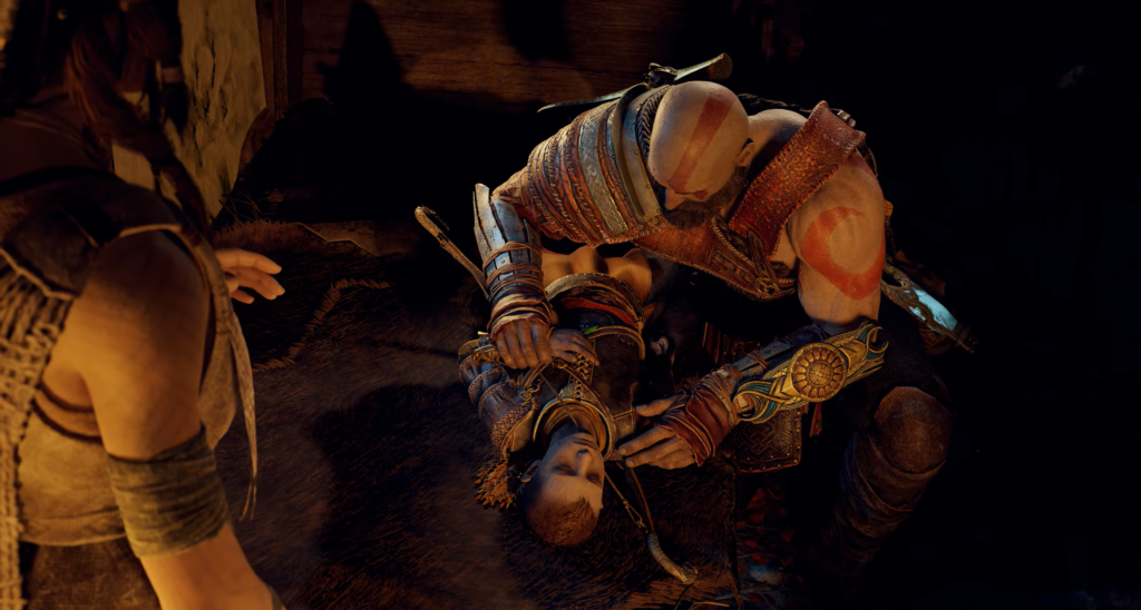Kratos cradles Atreus on floor in God of War