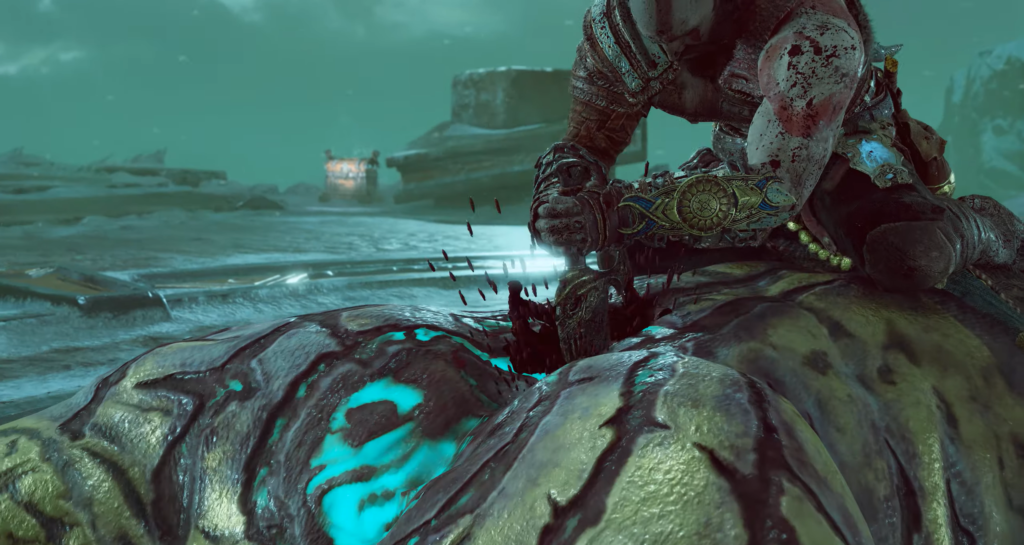 Kratos stabs enemy on rocky battlefield in God of War