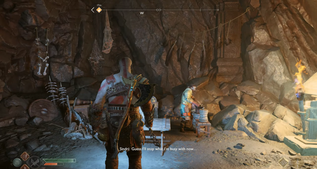 Kratos stands in cave near Sindri working bench