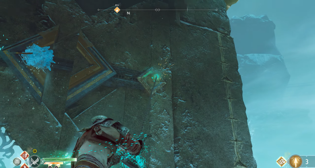 Kratos climbs icy stone wall in God of War