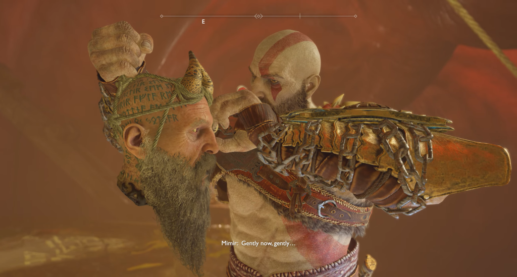 Kratos holds Mimir's head in God of War