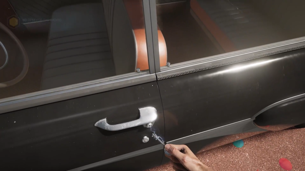 Hand unlocking black car door outdoors