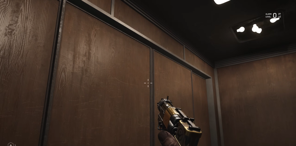 Holding pistol inside wood-paneled elevator cabin
