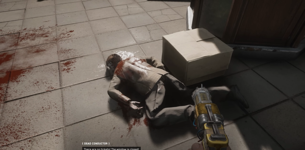 Dead conductor lying on tiled floor beside box