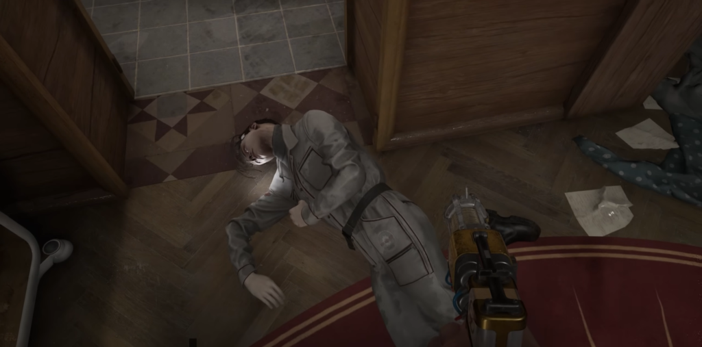 Person lying on floor beside gun indoors