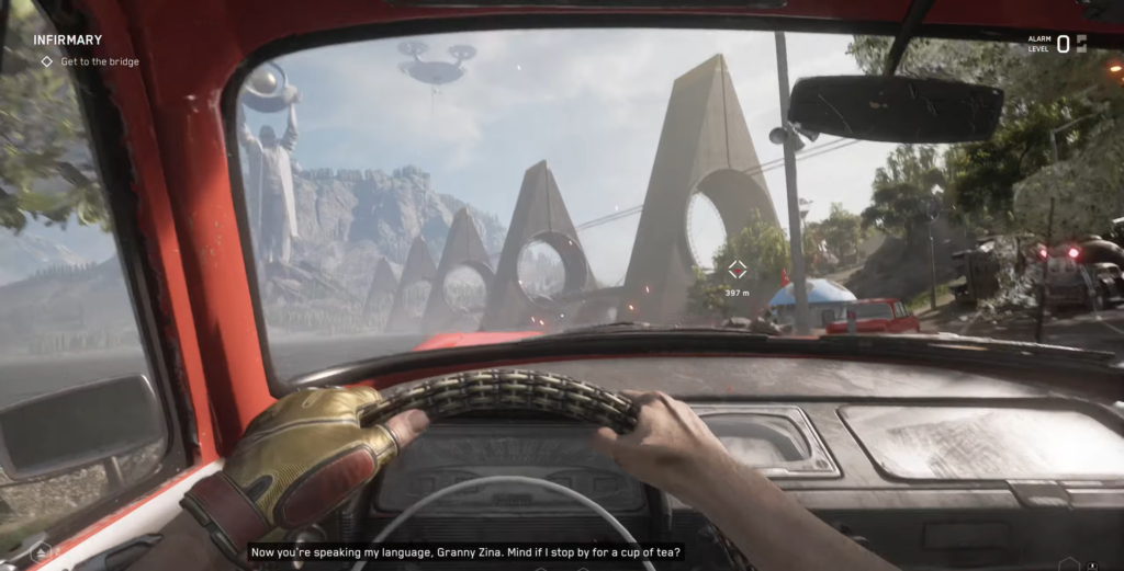 Driving red car toward concrete arches on road