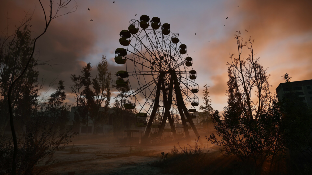 Ferris wheel stands in abandoned park at sunset