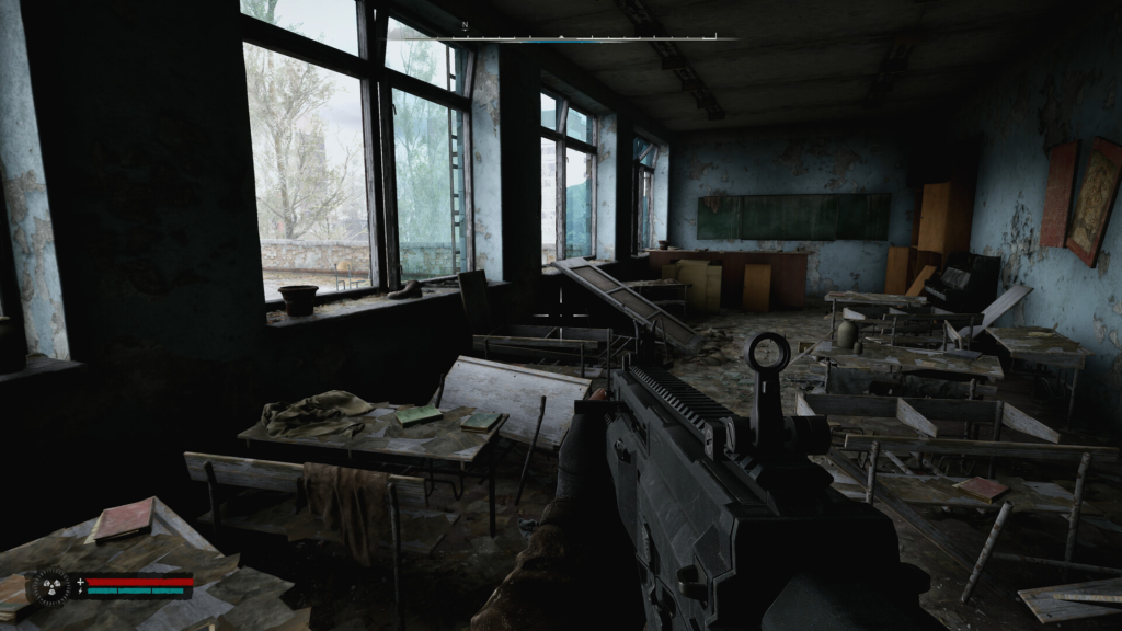 First-person rifle aiming inside abandoned classroom with desks
