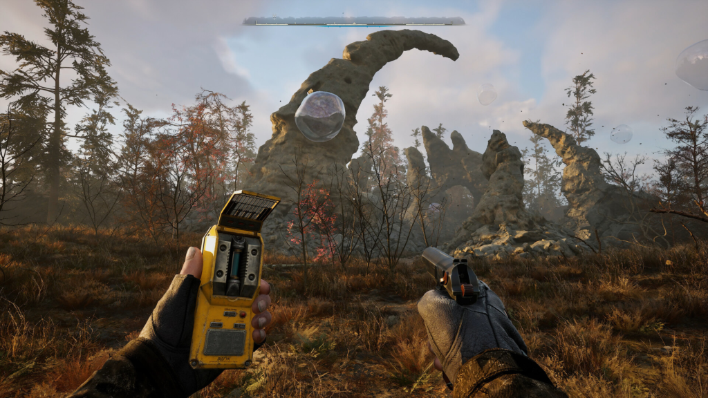 Hands holding detector and pistol in rocky forest